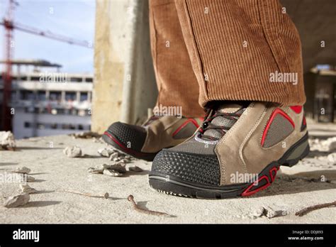 Safety boots, housing construction, construction site Stock Photo - Alamy