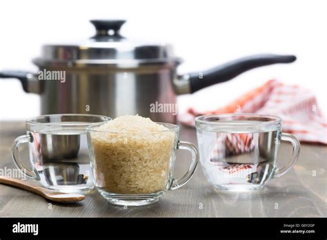 The recipe for steamed rice. One cup of rice and two cups of water Stock Photo - Alamy