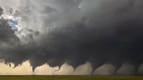 Download Captivating Tornado Formation Against a Stormy Sky | Wallpapers.com