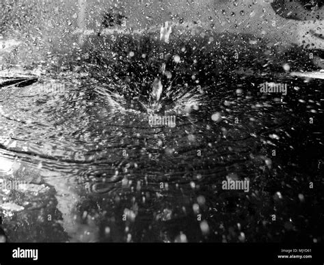 squirt a drop of water, colorless water spray close, dark tone Stock Photo - Alamy