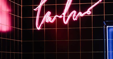 Photo of a Pink Neon Sign on Black Tiles · Free Stock Photo