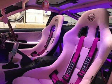 the interior of a car with pink leather seats