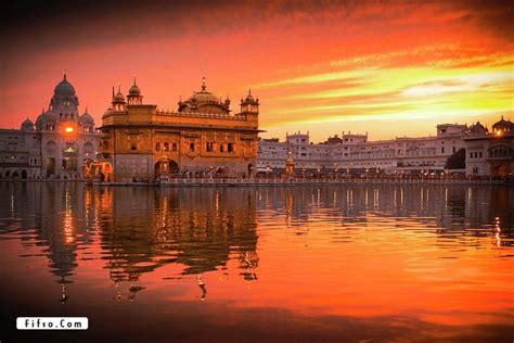 the golden temple is reflected in the water at sunset or dawn, with its ...