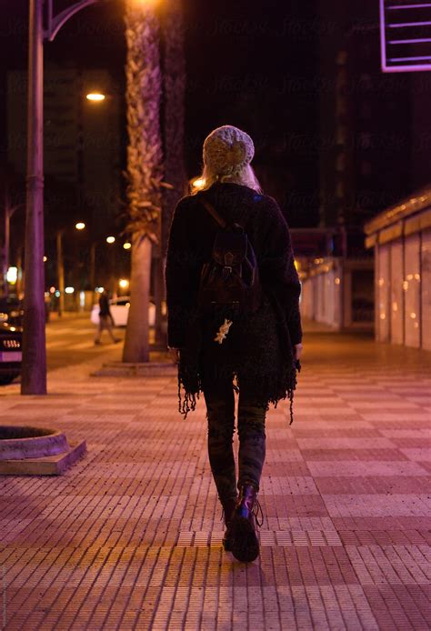 "Woman Walking On Night Street" by Stocksy Contributor "Milles Studio" - Stocksy