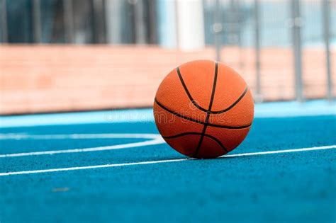 Orange Basketball Ball on the Blue Surface Stock Photo - Image of ...