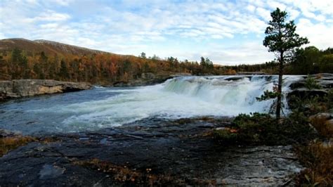 Nature sound of a loud waterfall flowing down the wet forest