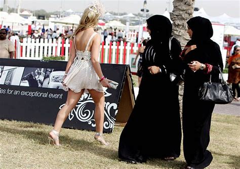 Two veiled Emirati women stare at a foreigner wearing a revealing... | Dresses in dubai, Theatre ...