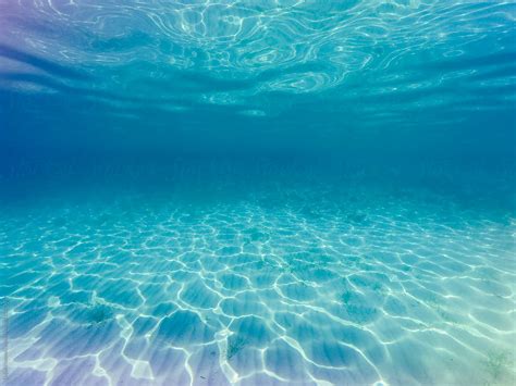 Sunray Ripples Underwater In Clear Blue Sea Water. by Dejan Ristovski