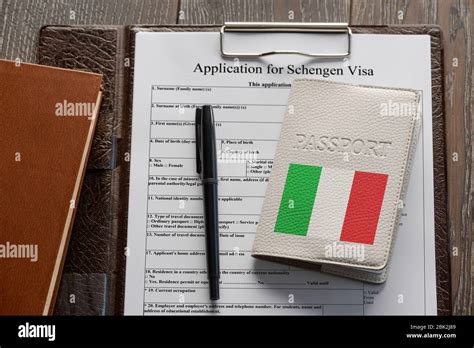 Application form, pen and an Italian passport Stock Photo - Alamy