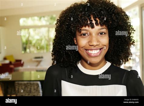 Mixed race businesswoman smiling in dining room Stock Photo - Alamy