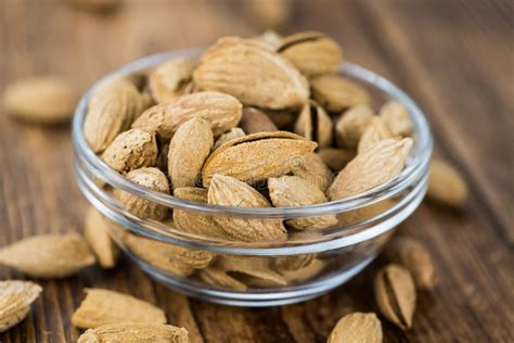 Roasted Almonds in Shell on a Wooden Table Selective Focus Stock Photo - Image of group, fruit ...