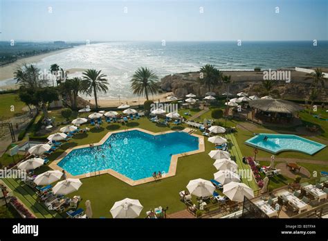 Oman, Muscat, Qurm. Crowne Plaza Hotel Pool and Qurm Beach Stock Photo - Alamy