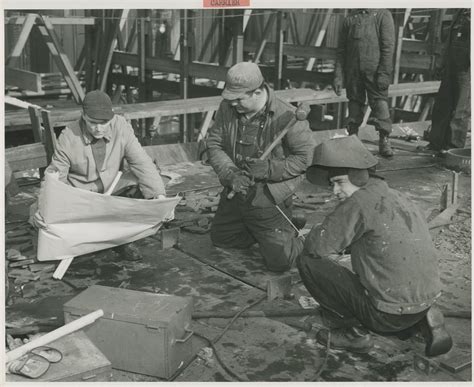 Shipyard workers push steadily ahead on the building of the first of the Navy's 45,000 ton ...