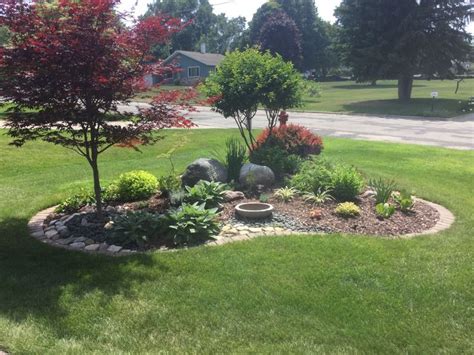 a small garden in the middle of a lawn