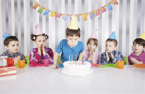 Cute boy blowing candles on birthday cake. - FAB