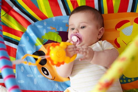 4-Month-Old Baby Girl Playing with Toys. Girl Pulling Hand for a Toy ...