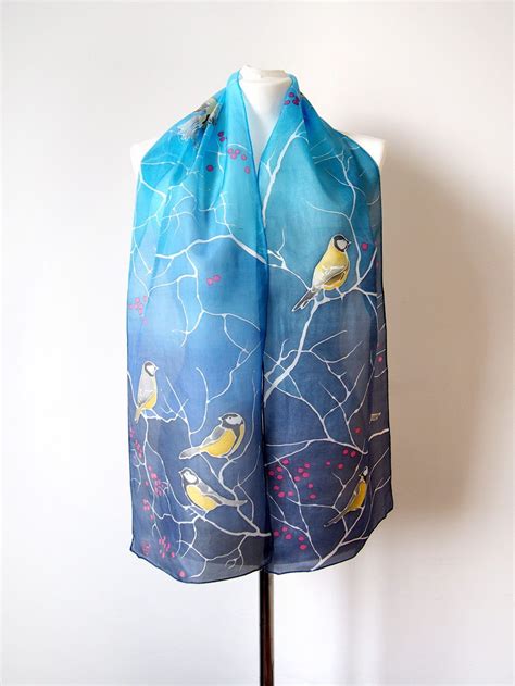 Blue Tit silk scarf is a hand painted Habotai natural silk slim scarf in blue, decorated with ...