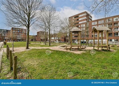 A Park with a Playground and Buildings in the Background Stock Photo ...