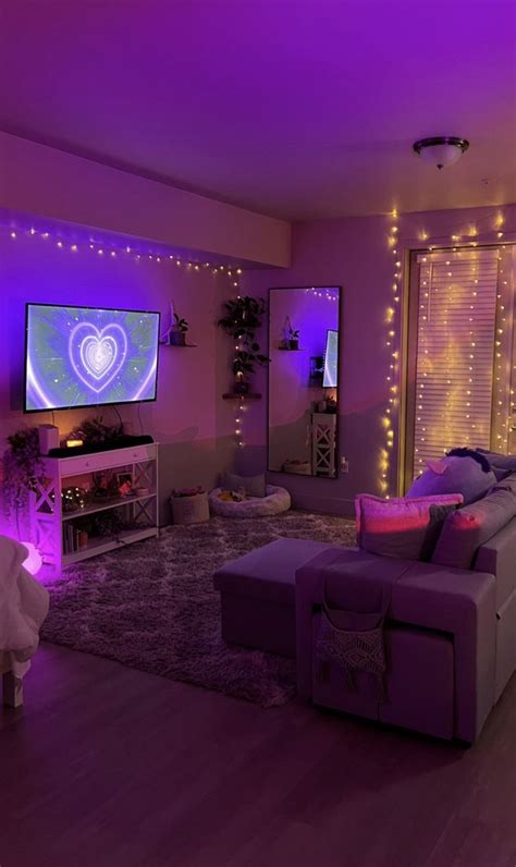 a living room filled with furniture and purple lights on the wall above it is a flat screen tv