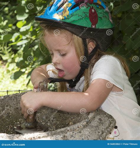 Child Drinking Water from a Fountain Stock Image - Image of helmet, public: 56853863