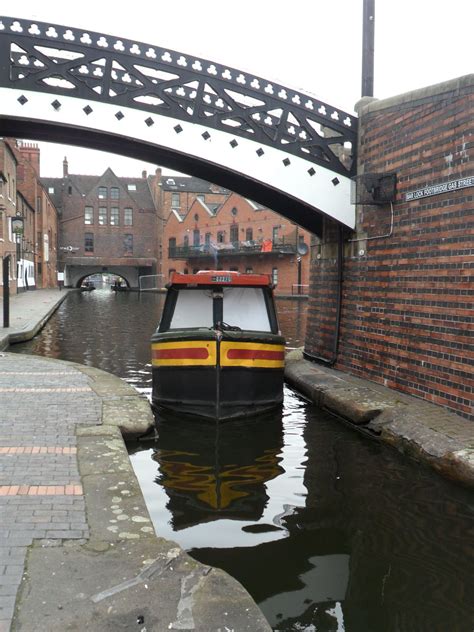 Canal Barge manoeuvres at the Bar Lock footbridge, Gas Street Basin, Birmingham, UK (All ...