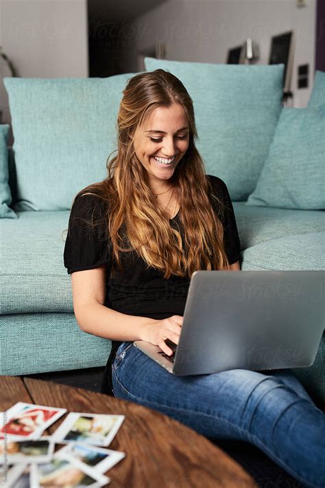 "Portrait Of Smiling Woman With Laptop At Home" by Stocksy Contributor "Guille Faingold" - Stocksy