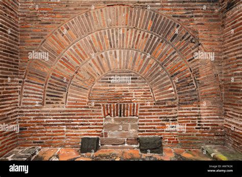 Roman wall with brick round arch above a sewer, Basilica of Constantine ...