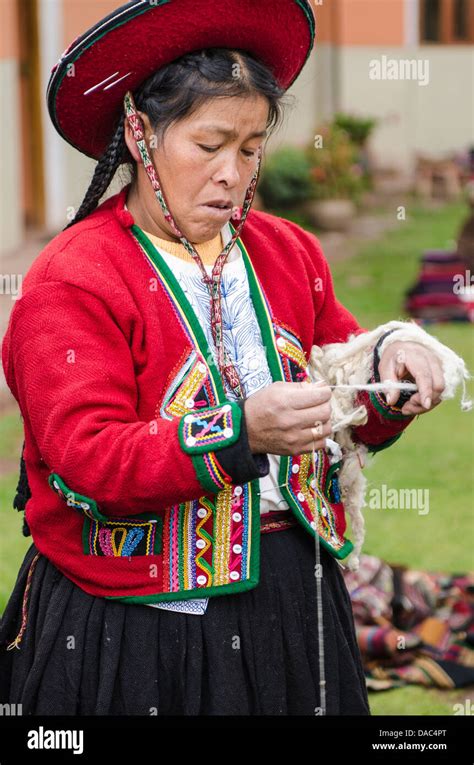 Traditionally red dress dressed costume clothing sweater Inca Incan woman spin spinning wool ...