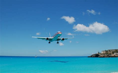 Download Hd Plane Flying Over Beach Wallpaper | Wallpapers.com