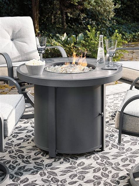 Donnalee Bay Outdoor Round Fire Pit Table by Signature Design by Ashley | FurniturePick