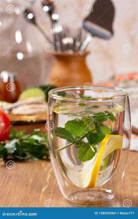 Refreshing Drink with Lemon and Mint in a Glass Cup Stock Photo - Image ...