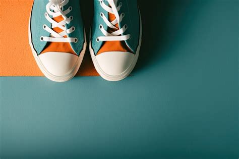 Premium Photo | A pair of blue and orange converse shoes with white laces.