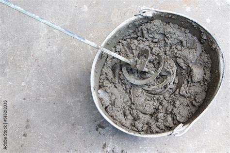 Mixing of concrete mortar.The builder prepares the cement mortar using a construction mixer ...