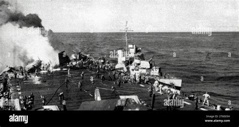 USS Helm (DD-388) assists USS Belleau Wood (CVL-24) after she was hit by a Kamikaze off Luzon ...