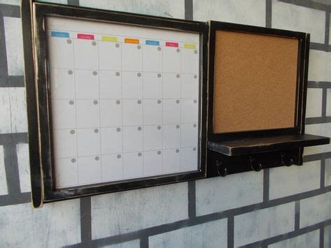 A Framed magnetic dry erase calender and a framed cork board with and a shelf and 3 key hooks ...