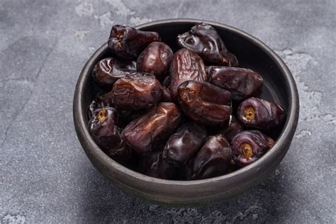 Premium Photo | Black dates healthy dried fruits