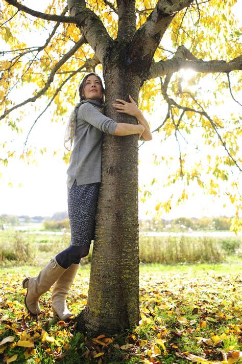 Woman tree hugging stock photo