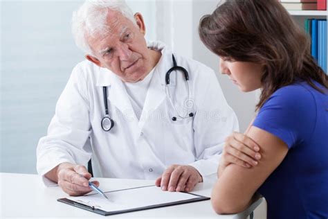 Doctor Doing Medical Interview Stock Photo - Image of sitting, desk: 50209330