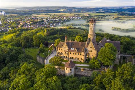 Germany, Bavaria, Bamberg, Helicopter view of Altenburg castle at foggy summer dawn stock photo