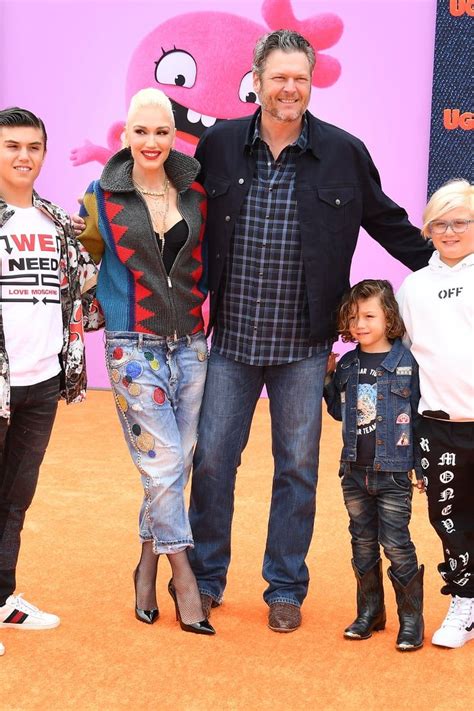 the family is posing for a photo on the orange carpet