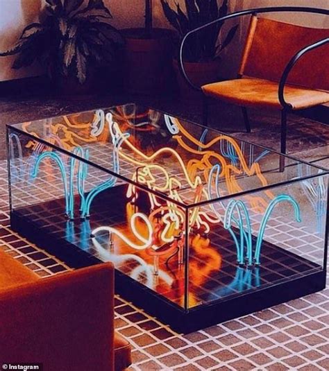 a glass coffee table with neon lights on it