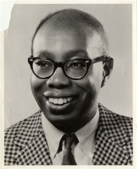 a black and white photo of a man wearing glasses