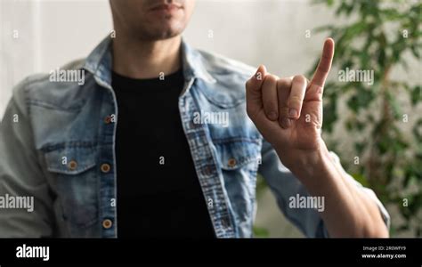 Sign language interpreter man translating a meeting to ASL, American Sign Language. Empty copy ...