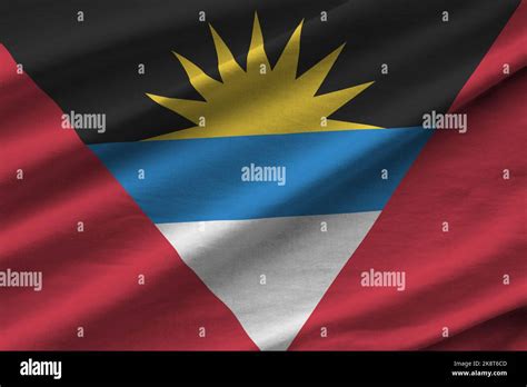 Antigua and Barbuda flag with big folds waving close up under the ...