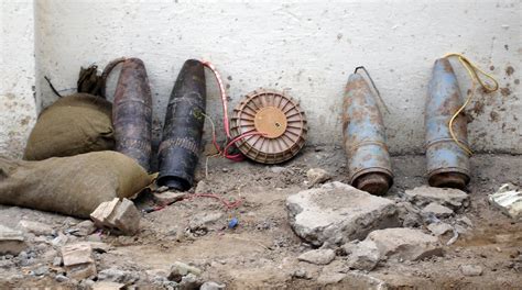 An improvised explosive device (IED) made by rigging four artillery shells and an anti-tank mine ...