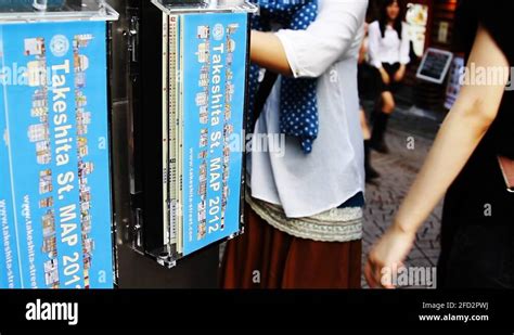 Pedestrians and Takeshita street map sign in Tokyo, Japan Stock Video Footage - Alamy