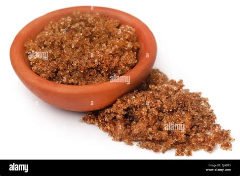 Brown sugar in a bowl over white background Stock Photo - Alamy