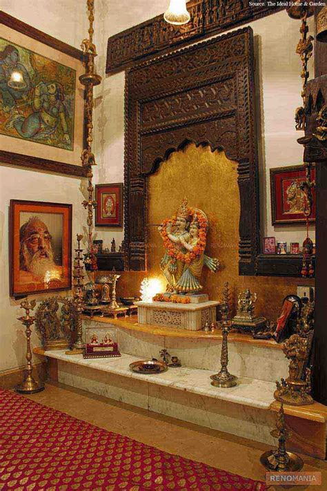 an elegant puja room with marble floor and hanging bells and idols ...