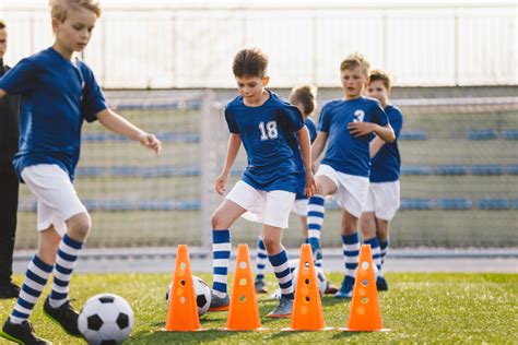 Soccer Boy on Training with Ball and Soccer Cones. Dribbling Drill. Soccer Kids Dribble Training ...