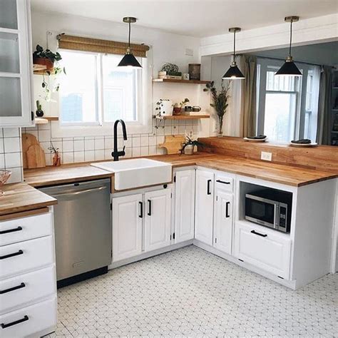 farmhouse kitchen with butcher block countertops white cabinets and pattern flooring #kitcheni ...